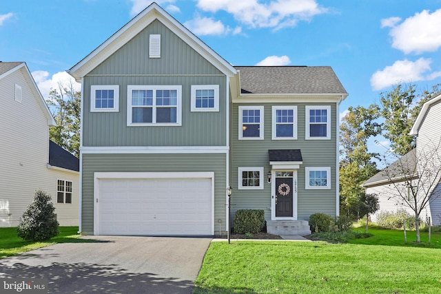 view of front of property featuring a front yard and a garage