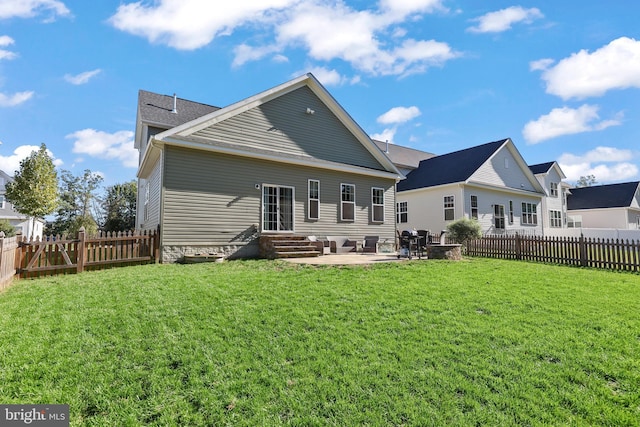 rear view of property featuring a patio area and a lawn