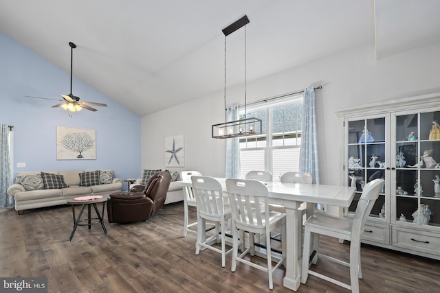 dining space featuring dark hardwood / wood-style floors, high vaulted ceiling, and ceiling fan