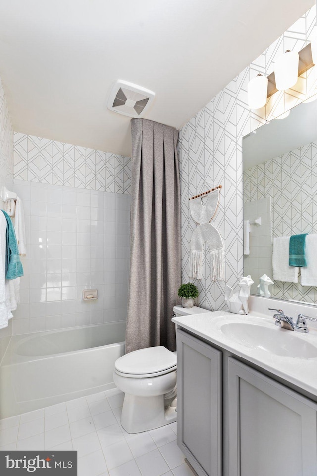 full bathroom with shower / tub combo, tile patterned floors, vanity, and toilet