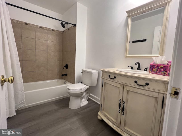 full bathroom with vanity, shower / tub combo with curtain, toilet, and hardwood / wood-style flooring