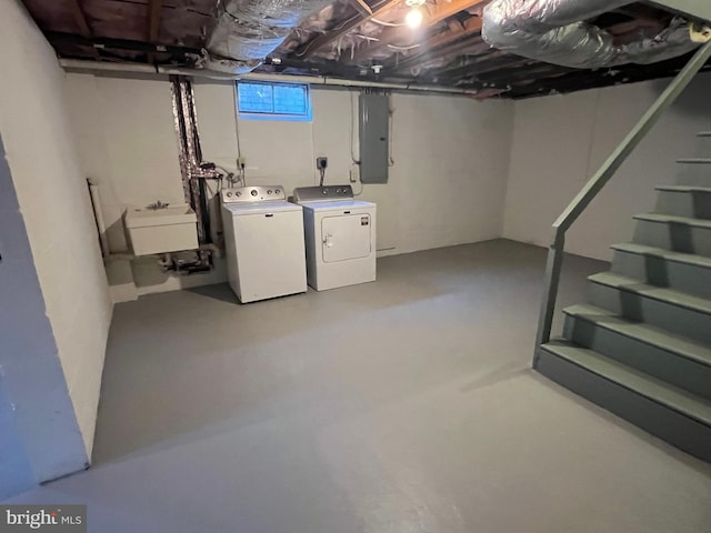 basement with electric panel, sink, and washer and clothes dryer