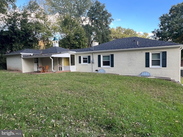 back of house with a patio and a yard