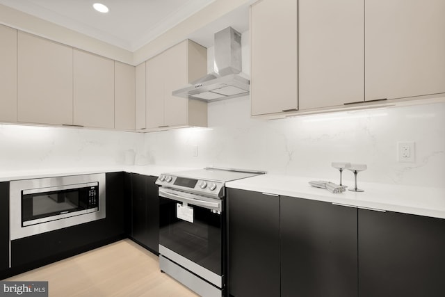 kitchen featuring tasteful backsplash, light hardwood / wood-style flooring, wall chimney range hood, stainless steel appliances, and crown molding