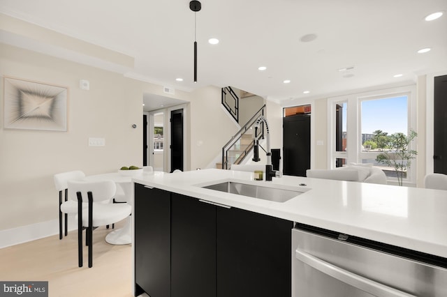 kitchen featuring pendant lighting, dishwasher, and sink