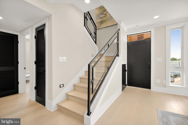 foyer with elevator and light hardwood / wood-style flooring