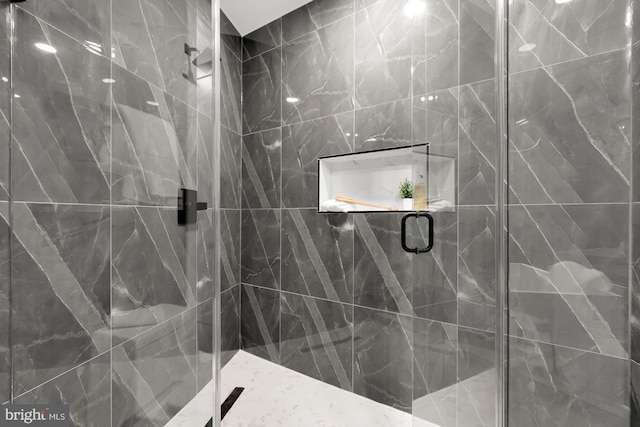 bathroom featuring walk in shower and tile walls