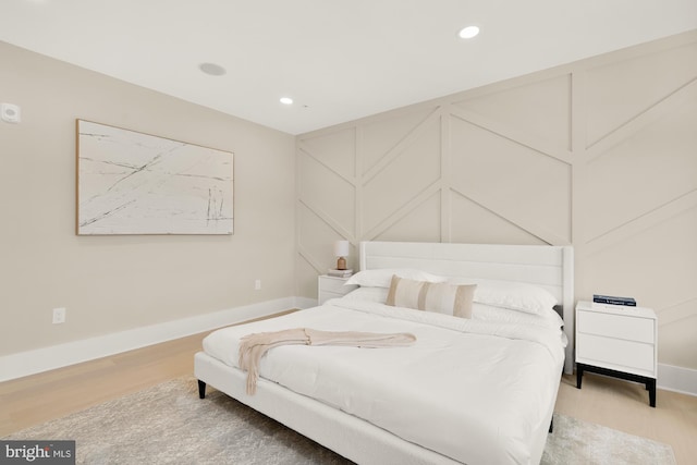 bedroom with hardwood / wood-style floors