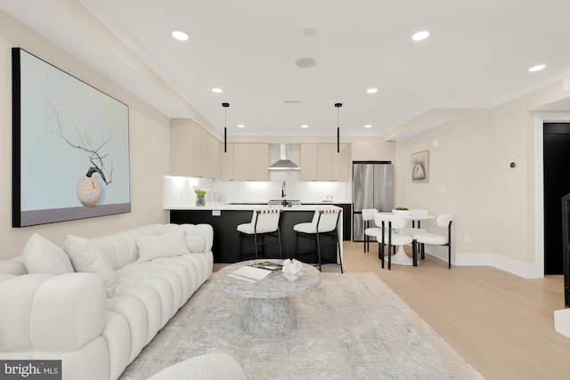 living room featuring ornamental molding and light wood-type flooring