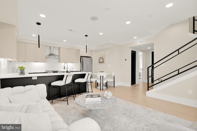 living room with sink and light hardwood / wood-style floors