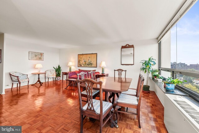 dining room featuring parquet floors