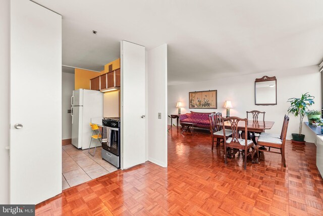 dining space with light parquet flooring