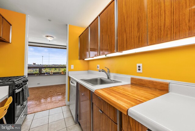 kitchen featuring sink, appliances with stainless steel finishes, and light tile patterned flooring