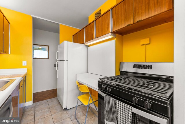 kitchen featuring appliances with stainless steel finishes and light tile patterned flooring