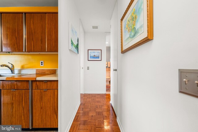 corridor featuring dark parquet floors and sink