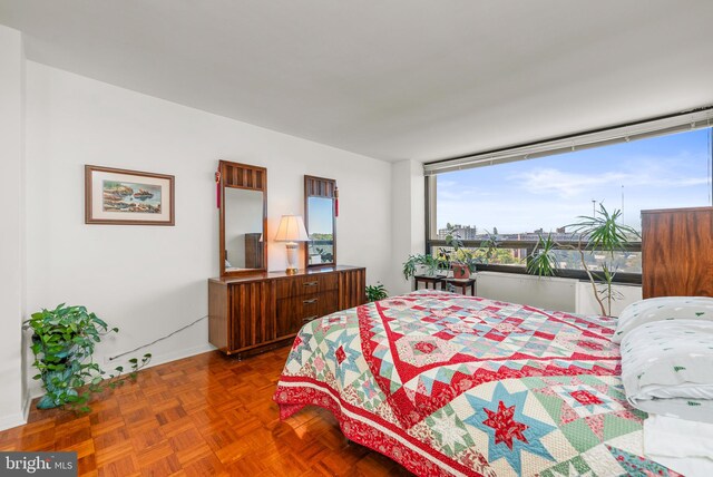 bedroom with dark parquet flooring