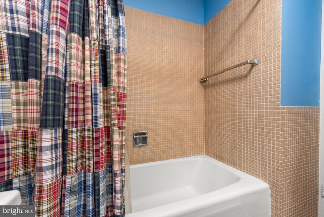 bathroom with shower / bath combination with curtain