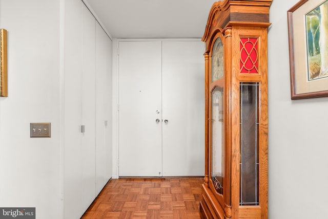 hallway featuring parquet flooring