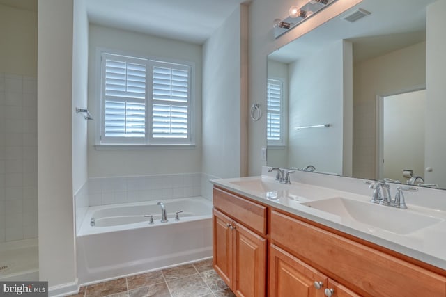 bathroom with vanity and a tub