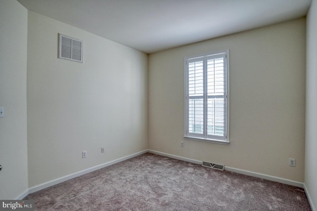 empty room featuring light carpet