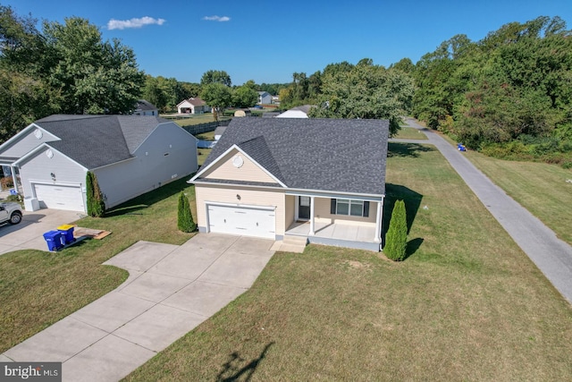 view of front of home with a garage and a front lawn