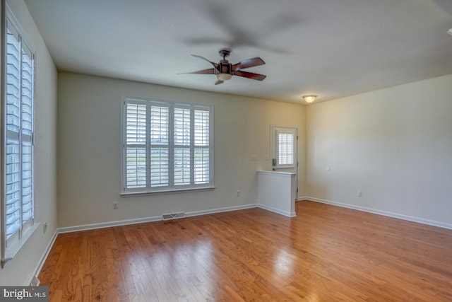 unfurnished room with light wood-type flooring and ceiling fan