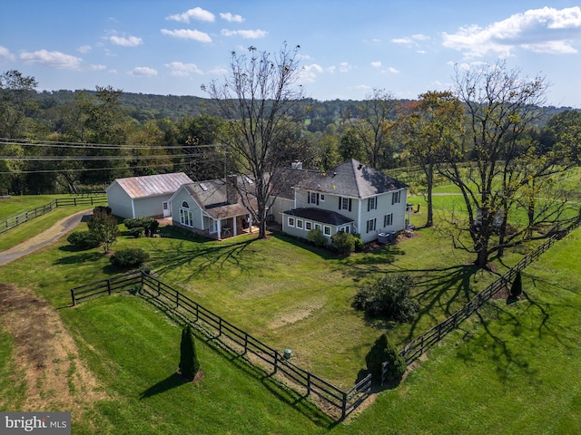 aerial view with a wooded view and a rural view