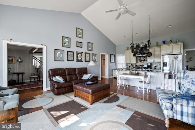 living room with high vaulted ceiling, light wood-type flooring, and ceiling fan