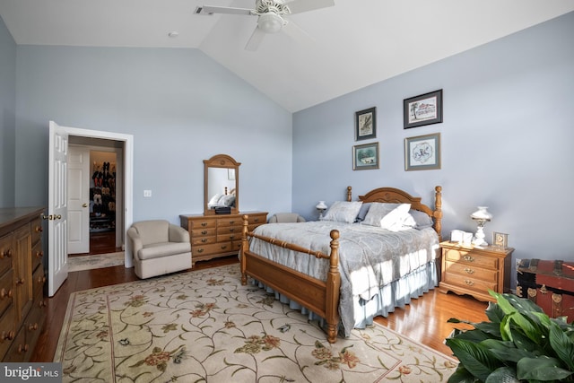 bedroom with wood finished floors, high vaulted ceiling, and a ceiling fan