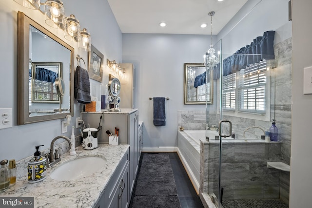 bathroom featuring tile patterned flooring, vanity, and shower with separate bathtub