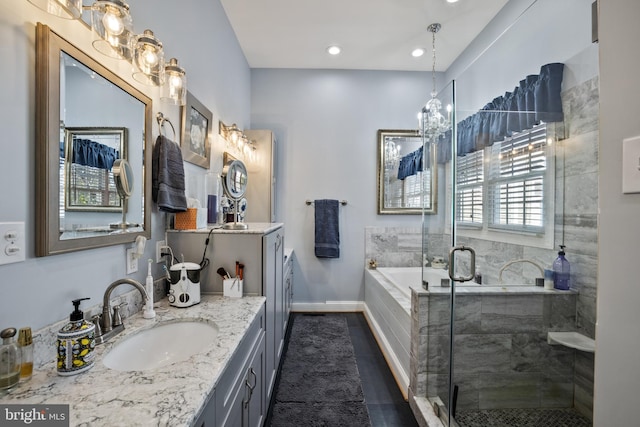 bathroom featuring two vanities, a sink, tile patterned flooring, a shower stall, and a garden tub