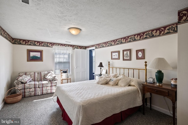 carpeted bedroom with a textured ceiling