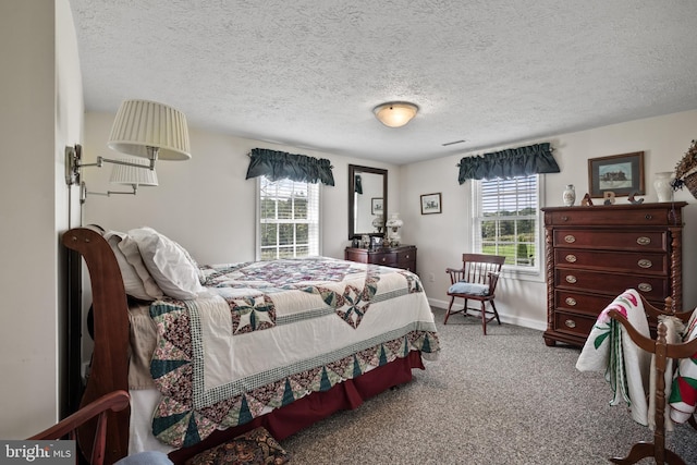 carpeted bedroom with multiple windows, baseboards, and a textured ceiling
