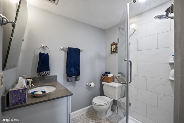 bathroom with toilet, vanity, and an enclosed shower