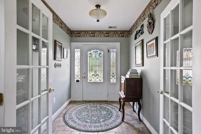 foyer entrance featuring french doors, baseboards, and visible vents