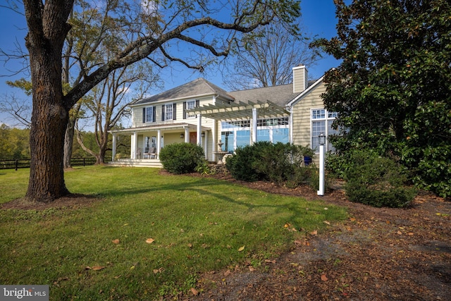 view of front of house featuring a front yard and a pergola