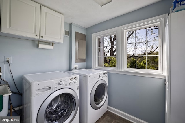 laundry room with washer and clothes dryer, cabinets, and dark hardwood / wood-style flooring