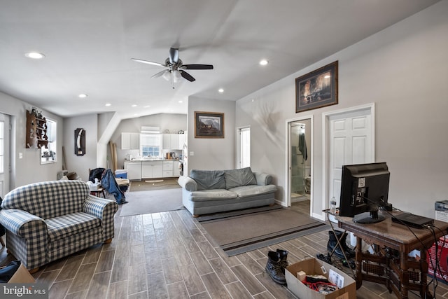 living room with ceiling fan, hardwood / wood-style flooring, and lofted ceiling