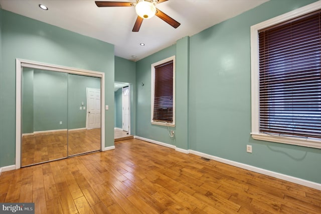 unfurnished bedroom with ceiling fan and wood-type flooring