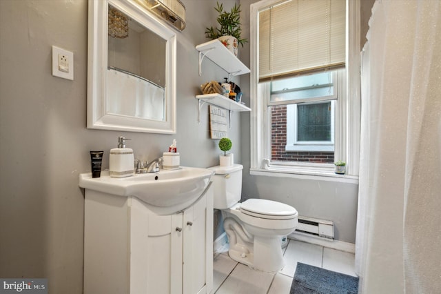 bathroom with tile patterned flooring, a baseboard radiator, vanity, and toilet