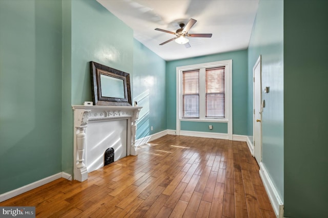 unfurnished living room with hardwood / wood-style flooring and ceiling fan