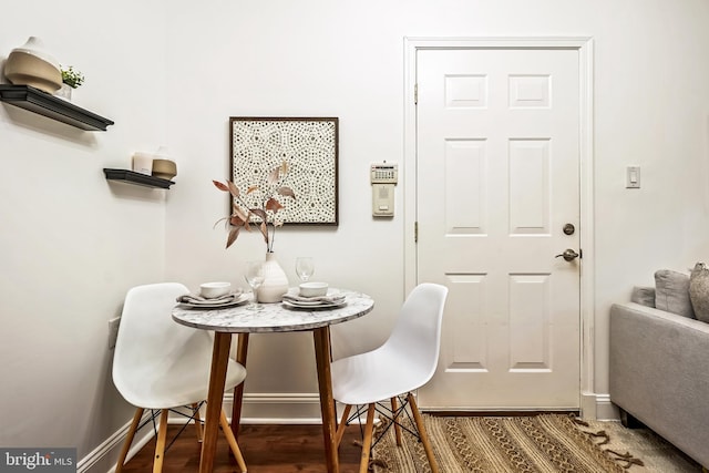 dining area featuring dark wood-type flooring