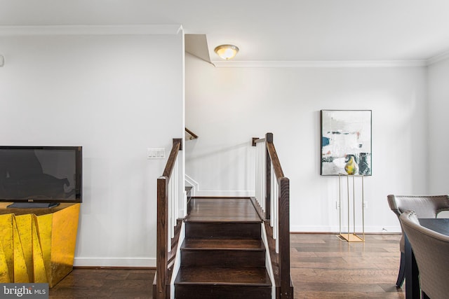 stairway with hardwood / wood-style flooring and crown molding