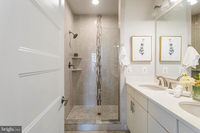 bathroom with vanity and a tile shower