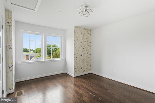 empty room with dark hardwood / wood-style flooring