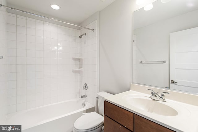 full bathroom with vanity, toilet, and tiled shower / bath