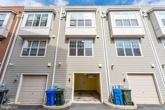 rear view of property with a garage