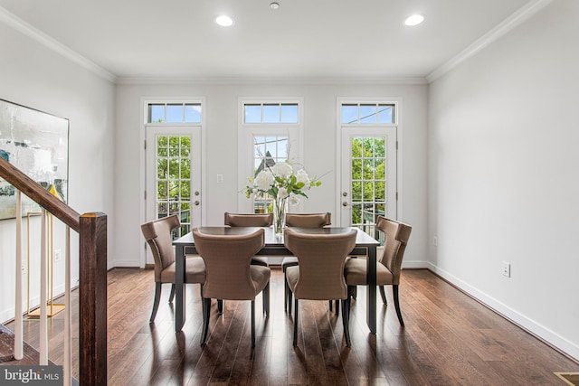 dining space featuring plenty of natural light, dark hardwood / wood-style floors, and crown molding