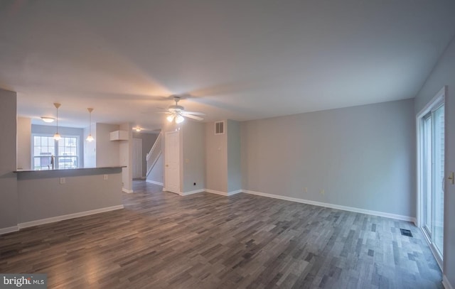 spare room with ceiling fan and dark hardwood / wood-style floors