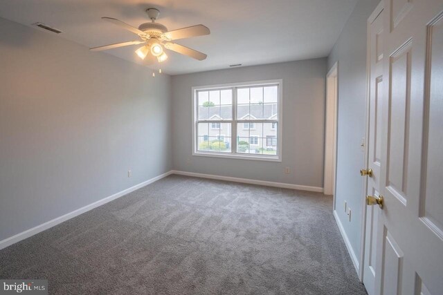 spare room featuring carpet flooring and ceiling fan